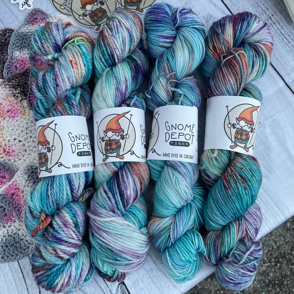 Gnome Depot fingering weight yarn in vibrant colors, perfect for lightweight knitting projects