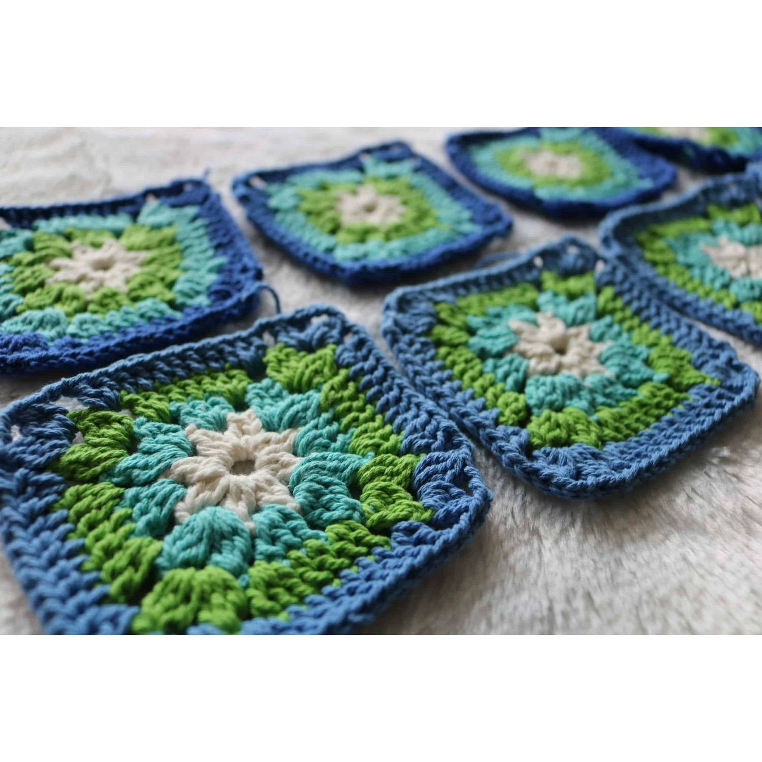 granny square crochet workshop showing blue green cream crochet squares in progress for beginner class