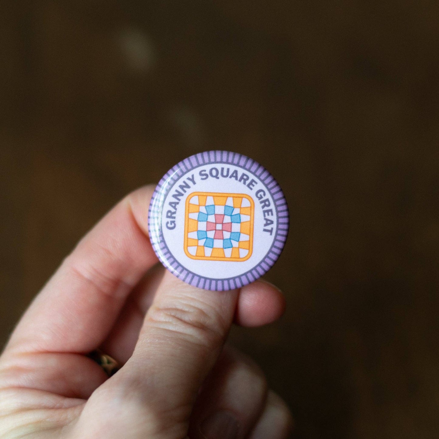 Colorful button with a square granny square pattern that reads Granny Square Great