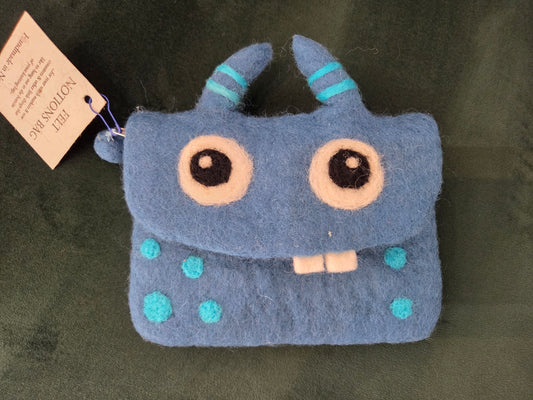 Frabjous Fibers blue monster pouch felt zipper coin pouch with striped horns big round eyes teal spots and two teeth