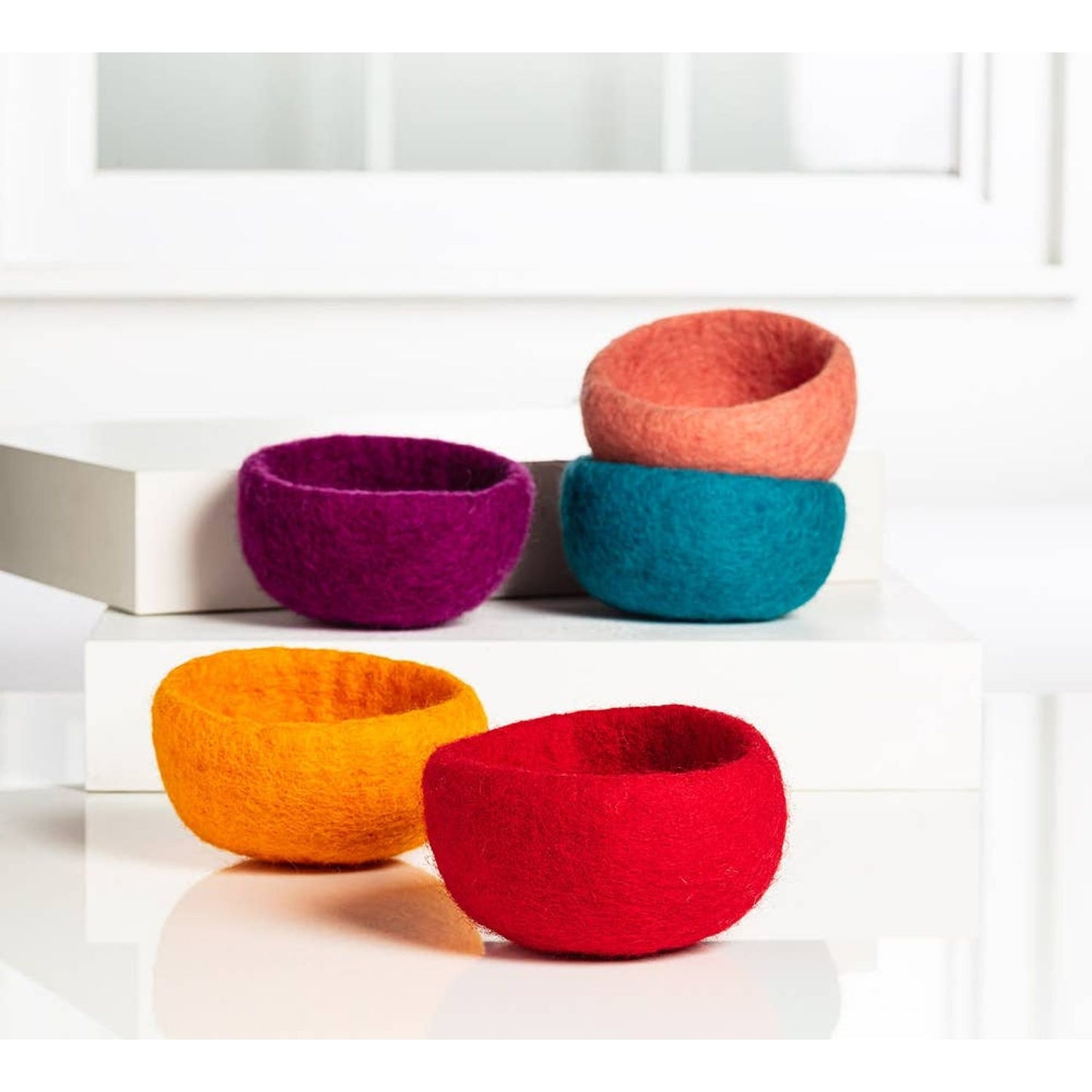 Colorful handmade yarn storage bowls in various sizes and hues for organizing your crafting supplies