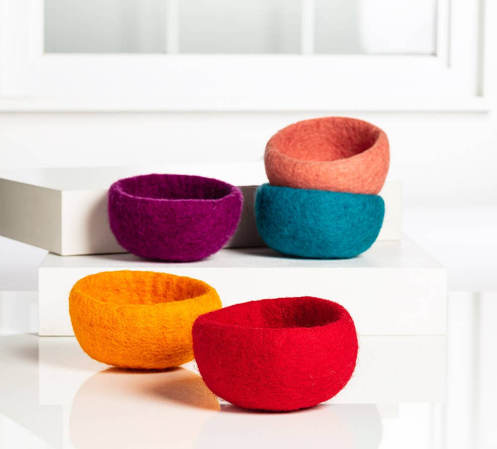 Colorful handmade yarn storage bowls in various sizes and hues for organizing your crafting supplies