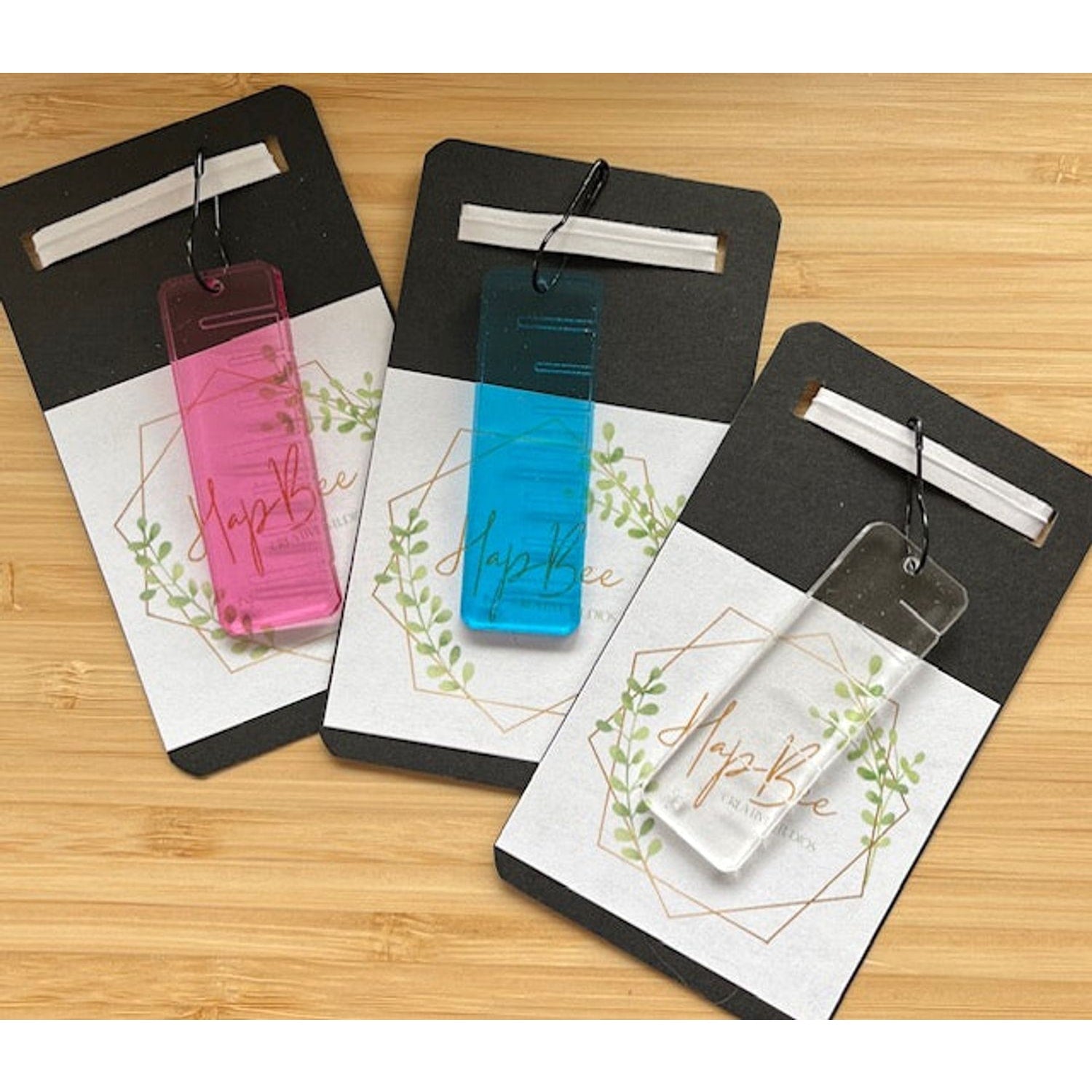 HapBee ruler stitch marker set of three translucent acrylic gauges in pink blue and clear on packaging