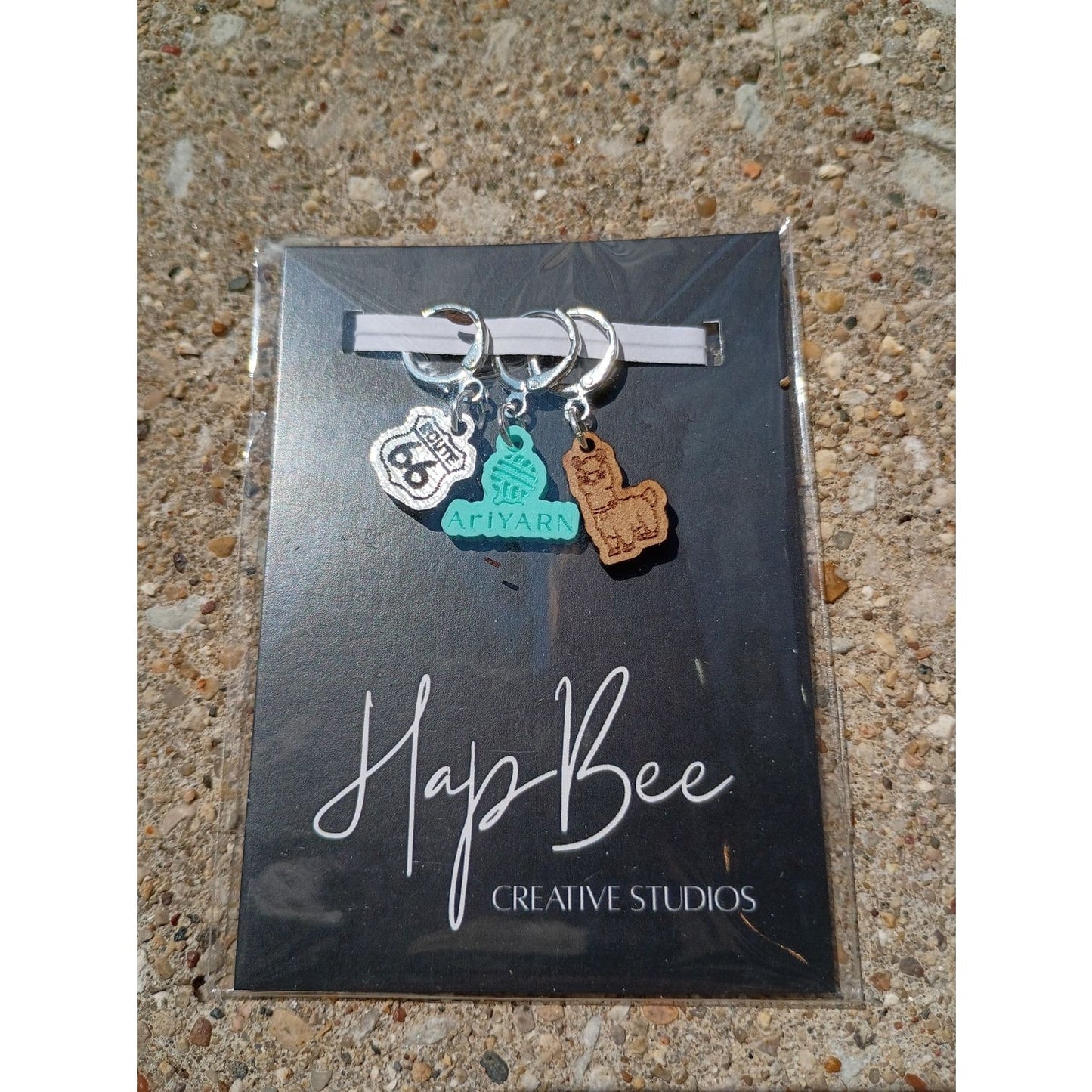 HapBee Creative Studios stitch markers for crocheting featuring a yarn ball and a llama charm