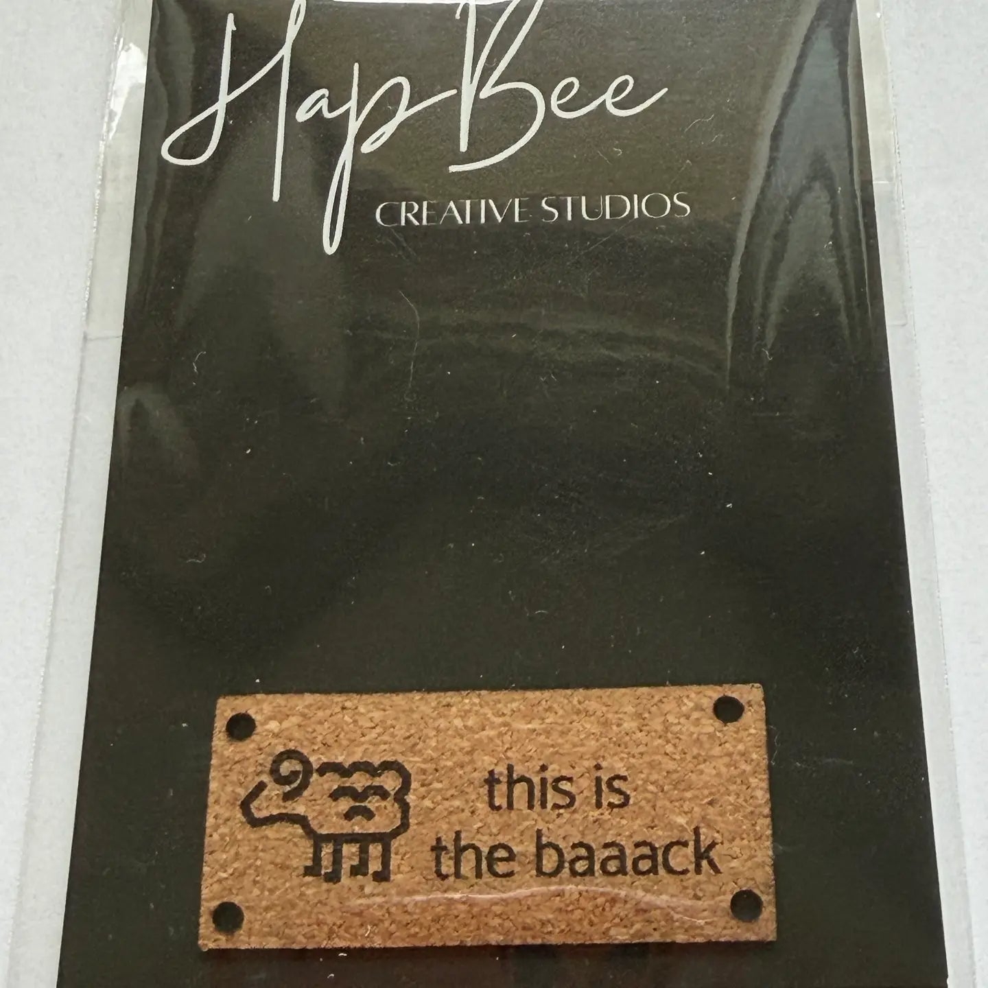 HapBee Creative Studios Cork Tag for Trunk Show with sheep design and 'this is the baaack' text