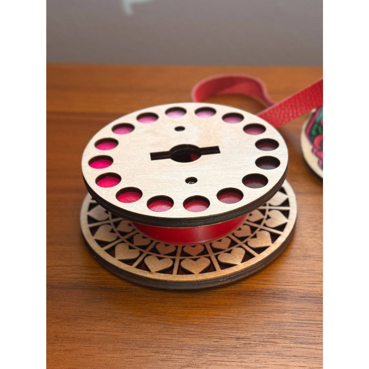 Lemonwood ribbon spool featuring a decorative design of hearts queen with vibrant pink ribbon