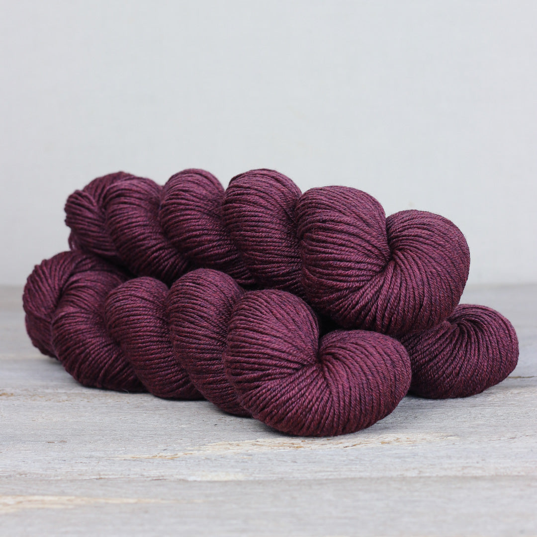 Rich burgundy Herb & Hue yarn for knitting in soft, luxurious fibers ideal for various projects
