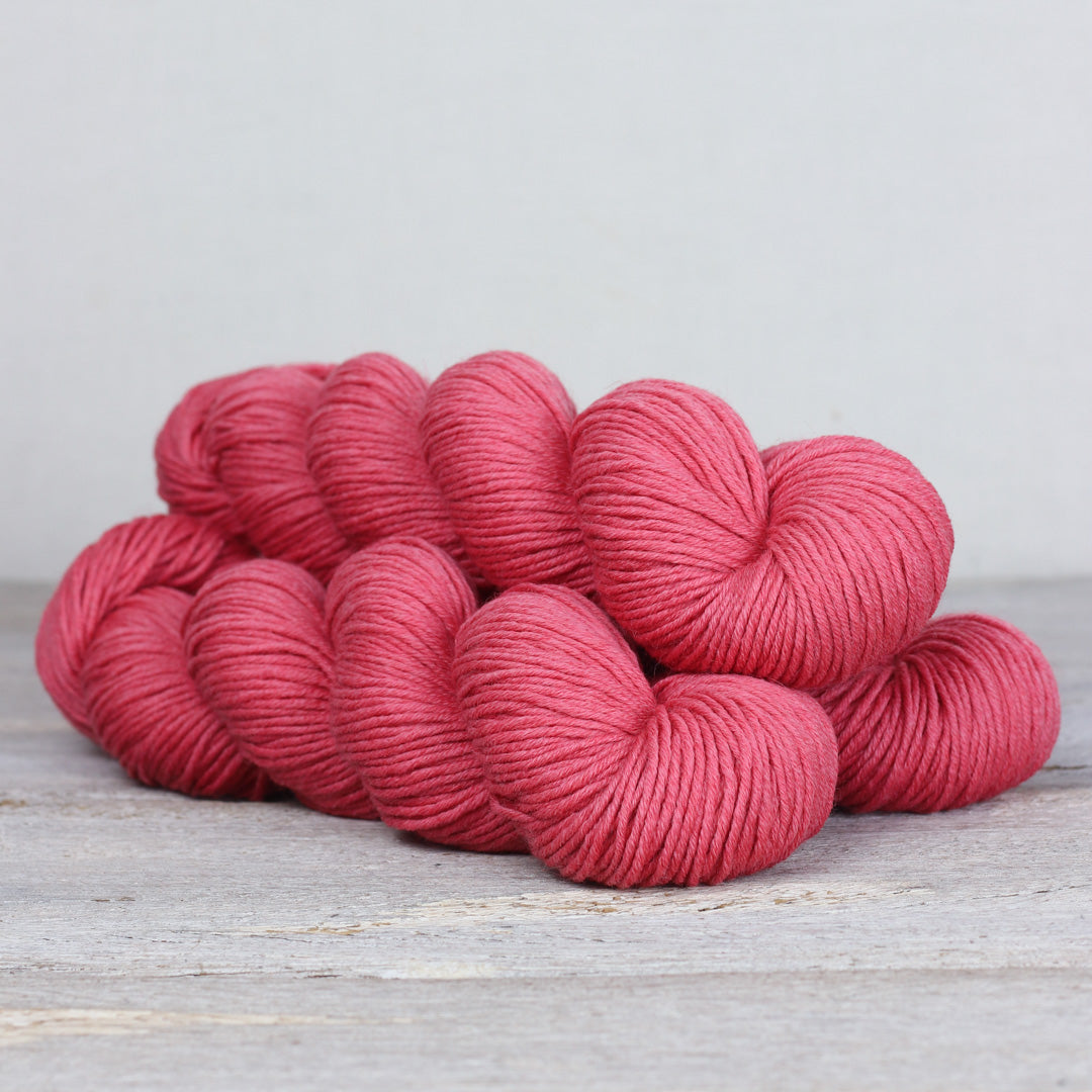Herb & Hue yarn for knitting in a soft pink shade, ideal for cozy projects and garments