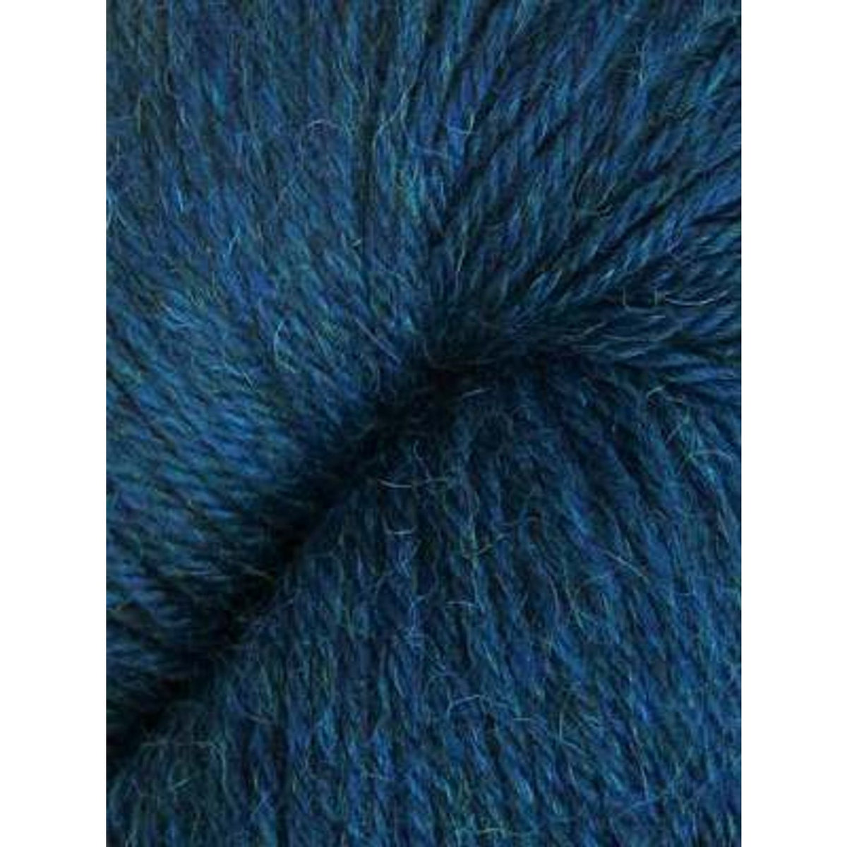 Close-up of Juniper Moon Farm Herriot yarn in deep blue, perfect for cozy knitting projects