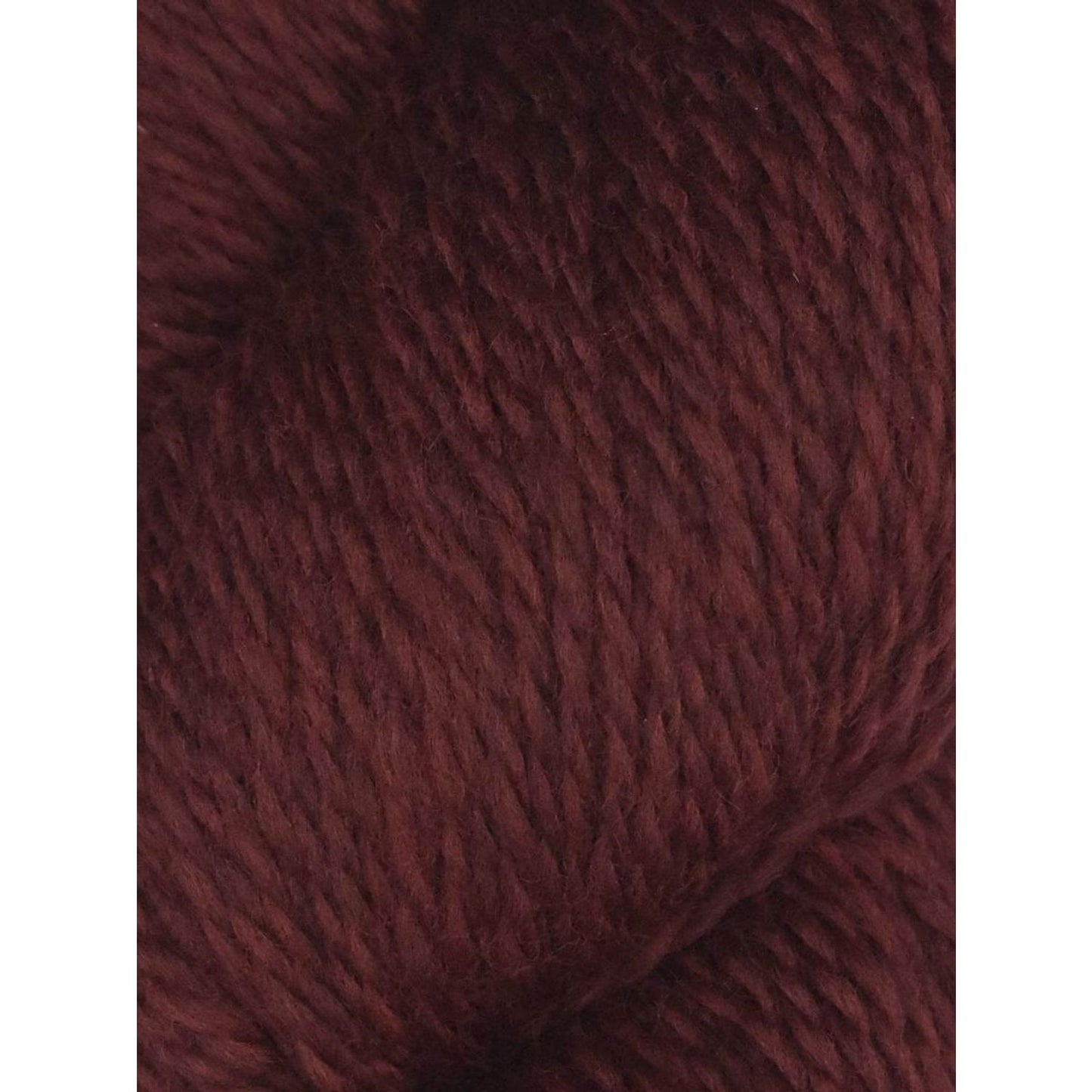 Close up of deep burgundy skein of Juniper Moon Farm Rambouillet yarn by Knitting Fever showing soft plied wool texture