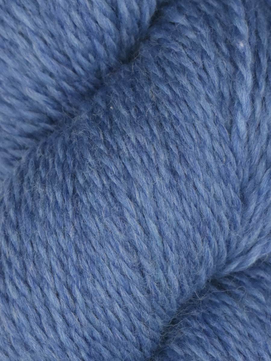 Close up of soft heathered blue skein of Juniper Moon Farm Rambouillet yarn by Knitting Fever