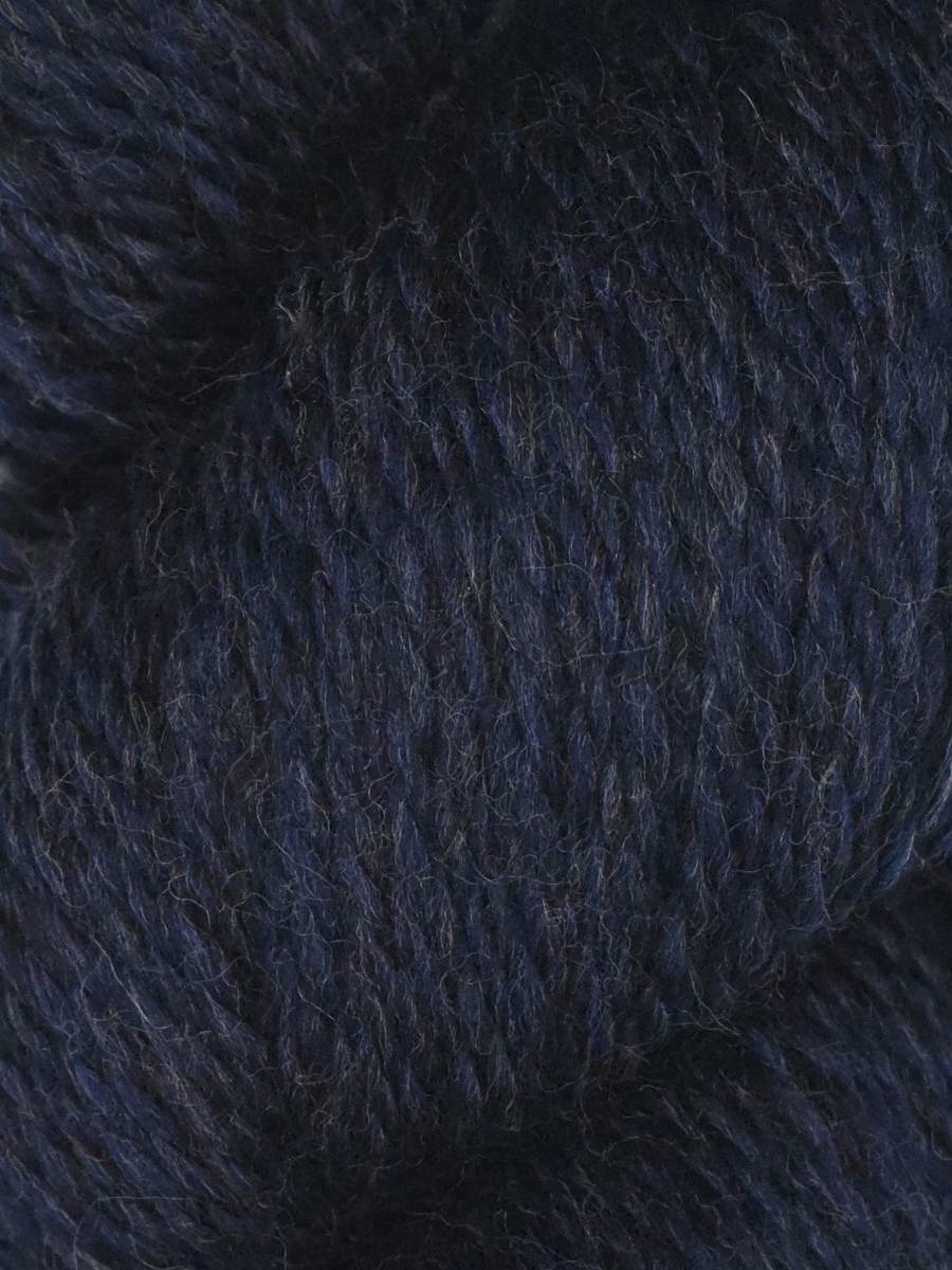Knitting Fever skein of Juniper Moon Farm Rambouillet yarn in deep navy heather closeup showing soft wool texture