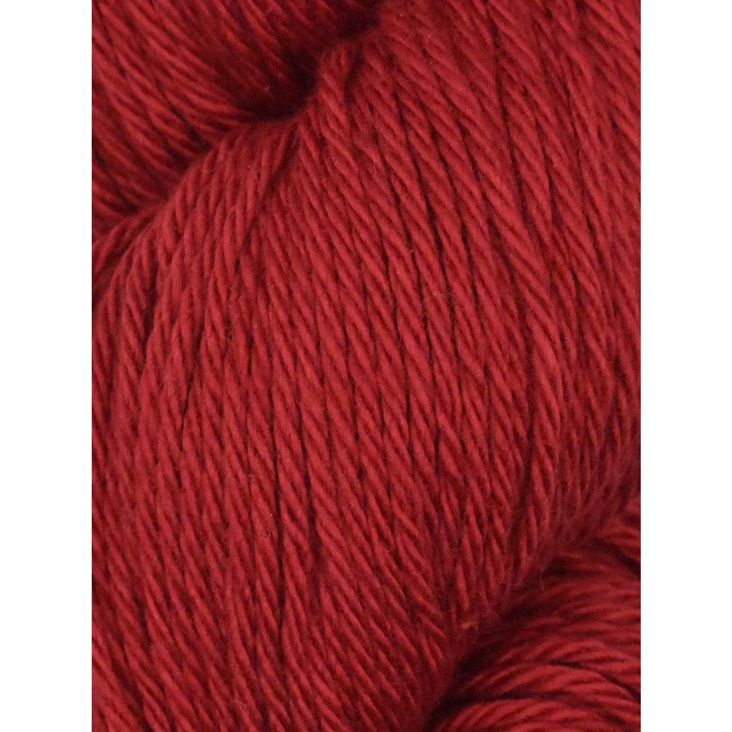 Rich red Juniper Moon Farm yarn with a soft texture perfect for knitting and crochet projects