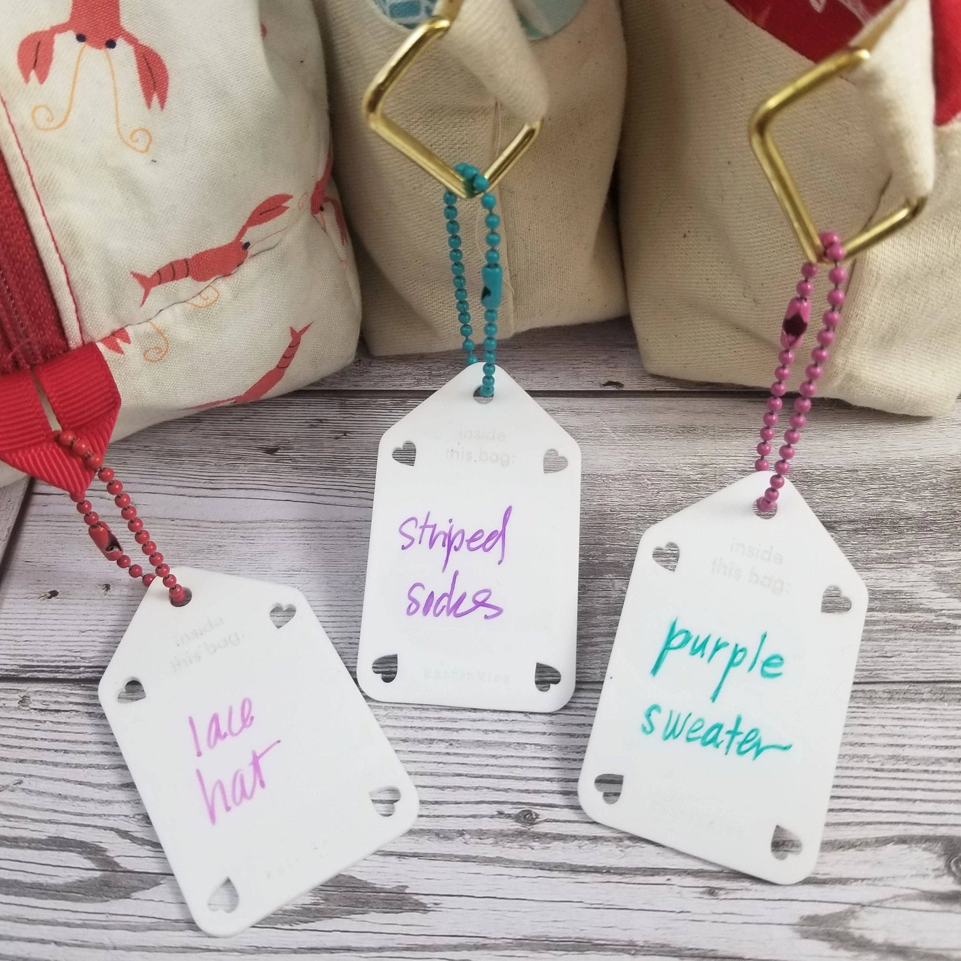 Colorful acrylic name tags with lace hat, striped sides, and purple sweater labels for easy identification
