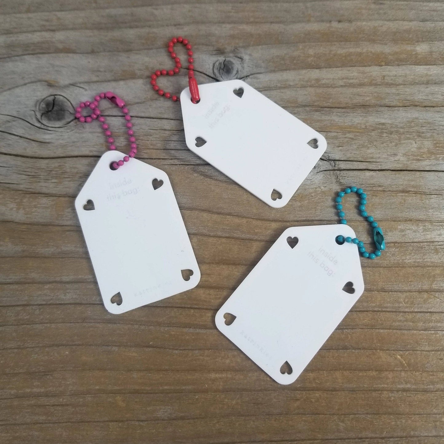Set of three Katrinkles acrylic name tags with heart cutouts and colorful beaded chains