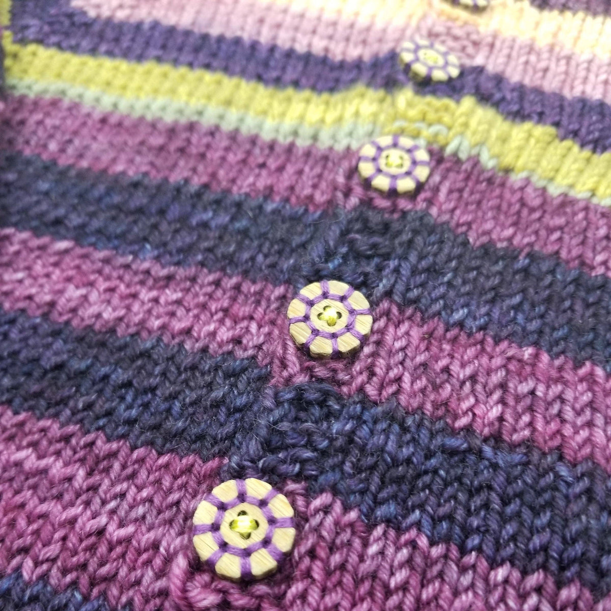 Colorful knitted garment featuring Katrinkles buttons shaped like bachelor buttons flower