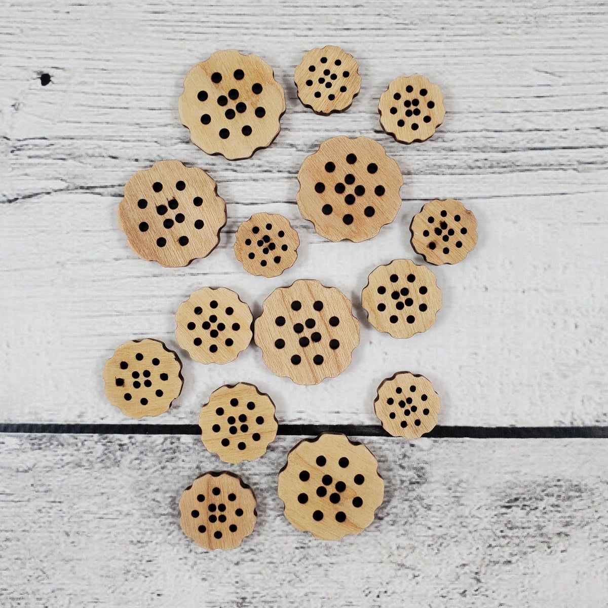 Set of wooden buttons in flower shapes featuring holes, styled as bachelor buttons flower for crafting