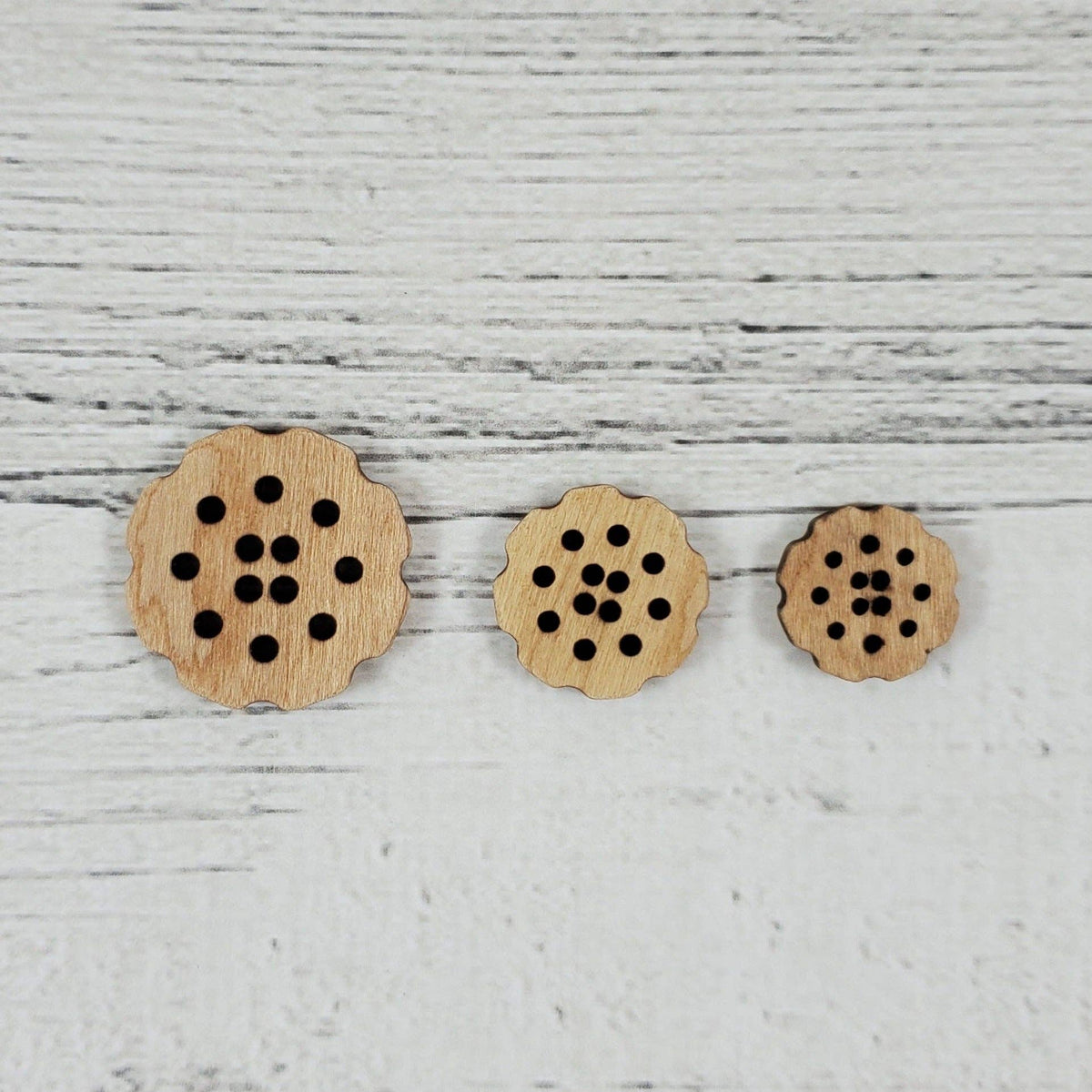 Set of three wooden buttons shaped like bachelor buttons flowers for crafting projects