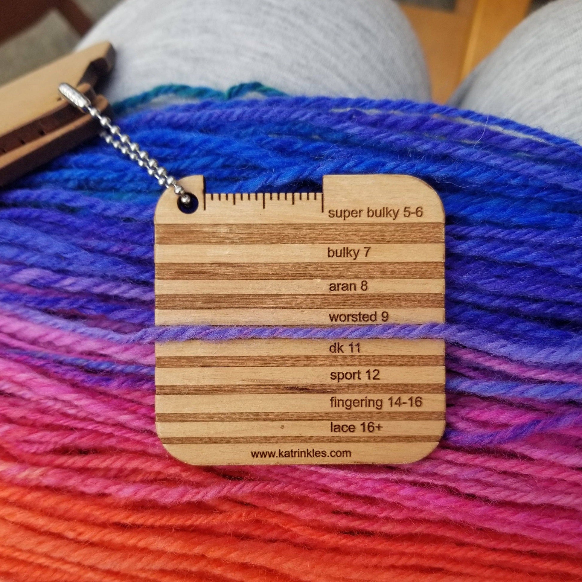Katrinkles DK Yarn Gauge in wood showing various yarn sizes and measurements for knitters