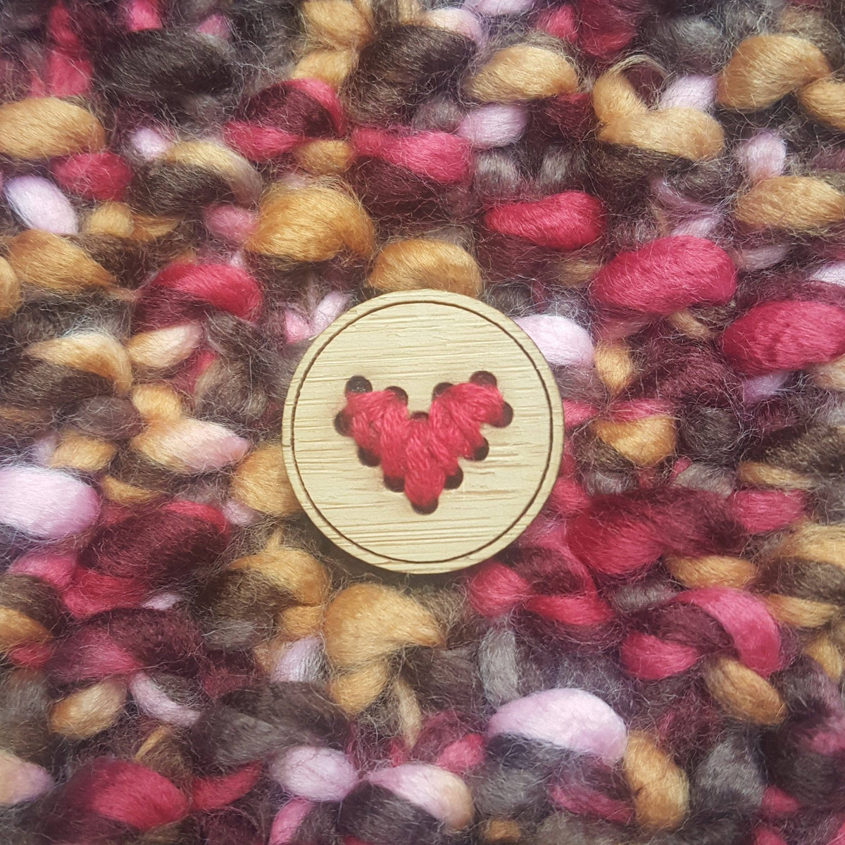 Katrinkles heart buttons in wood featuring red yarn stitched in a heart shape