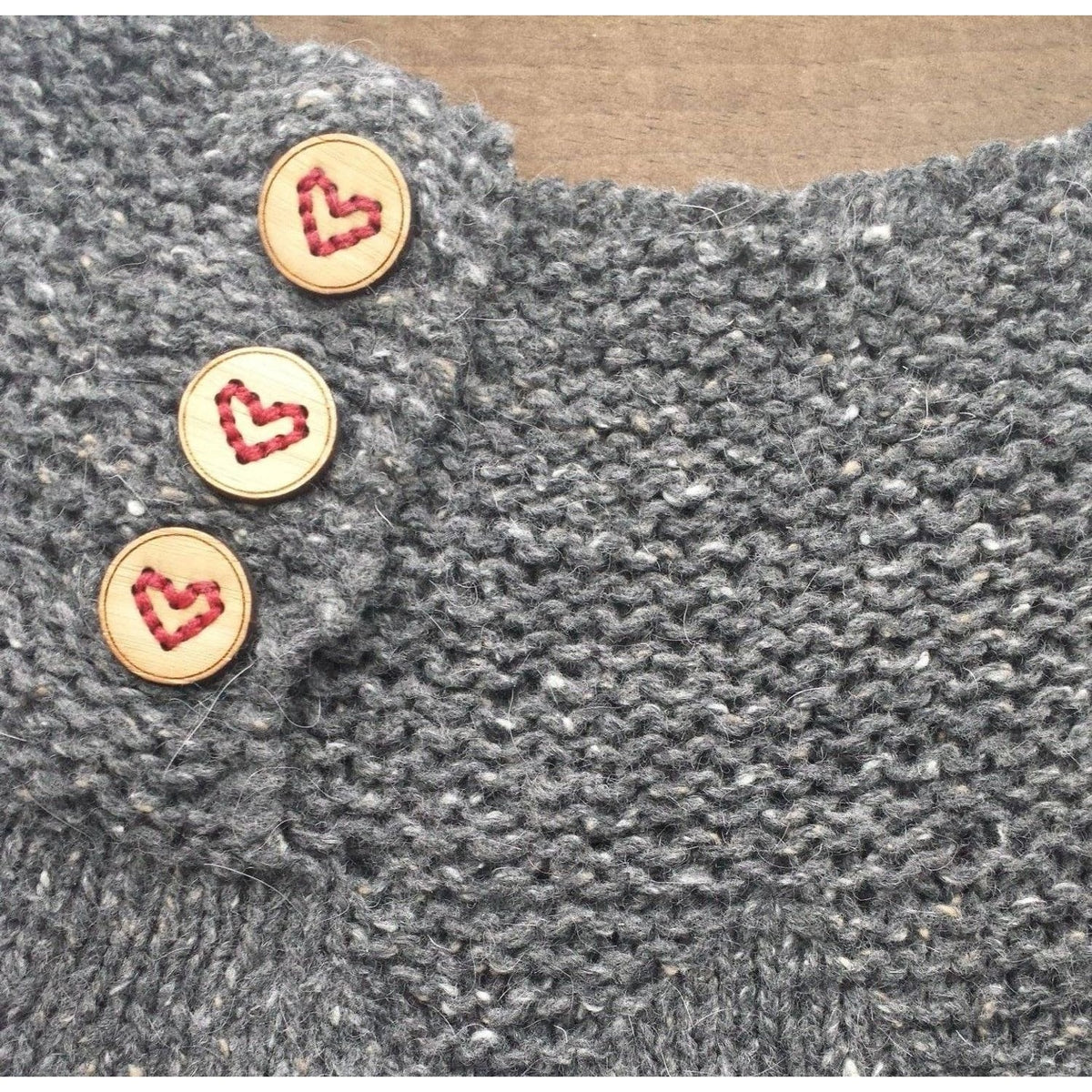 Katrinkles heart buttons on a gray knitted garment for a stylish finish