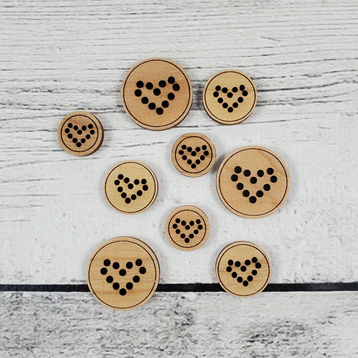 Katrinkles heart buttons in various sizes made of natural wood with black dot designs