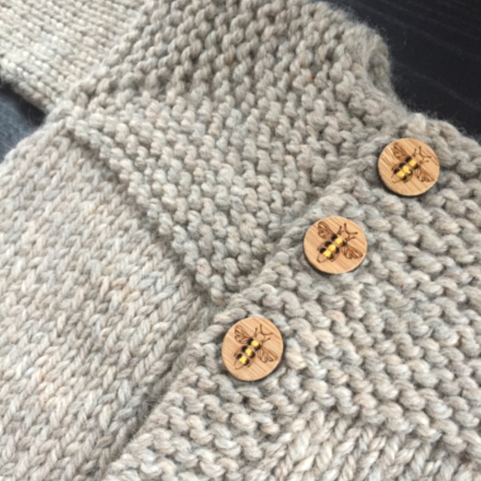 Katrinkles honey bee buttons on a hand-knit beige sweater showcasing natural fibers
