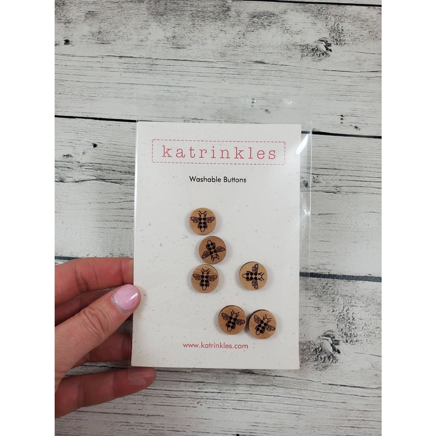 Katrinkles Washable Buttons featuring honey bee design on wooden material for crafting projects