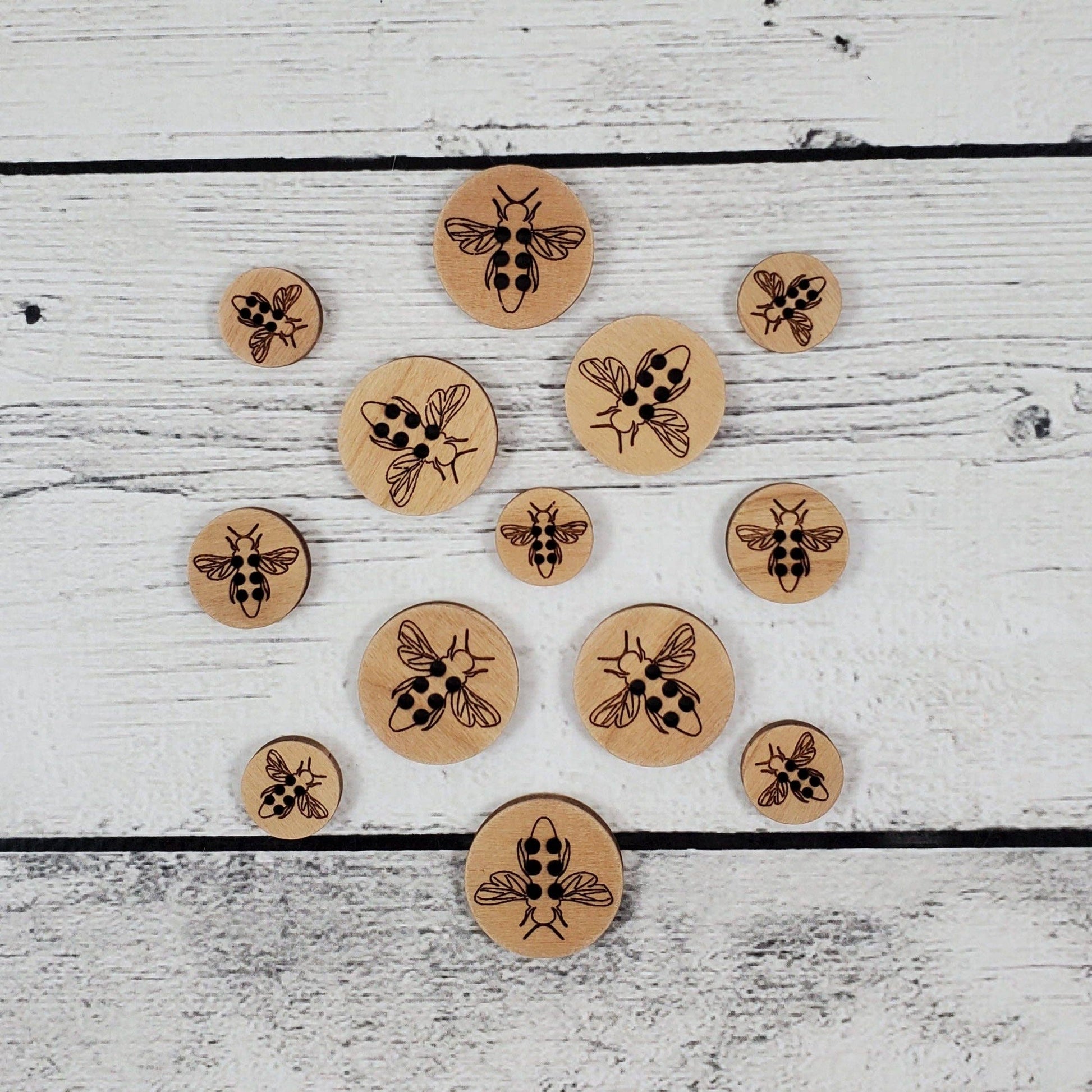 Katrinkles honey bee wood pins in various sizes featuring intricate engravings of bees