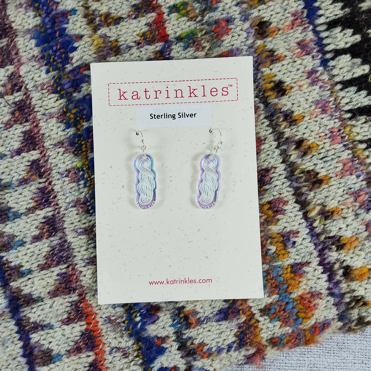 Katrinkles iridescent earrings on a display card, showcasing a unique design in sterling silver