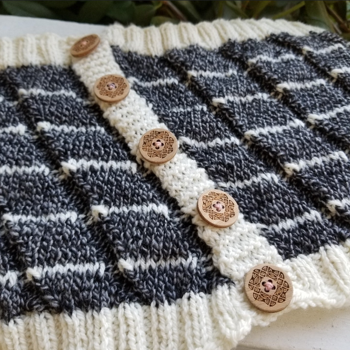 Katrinkles hand-knit accessory featuring a striped pattern and decorative wooden buttons