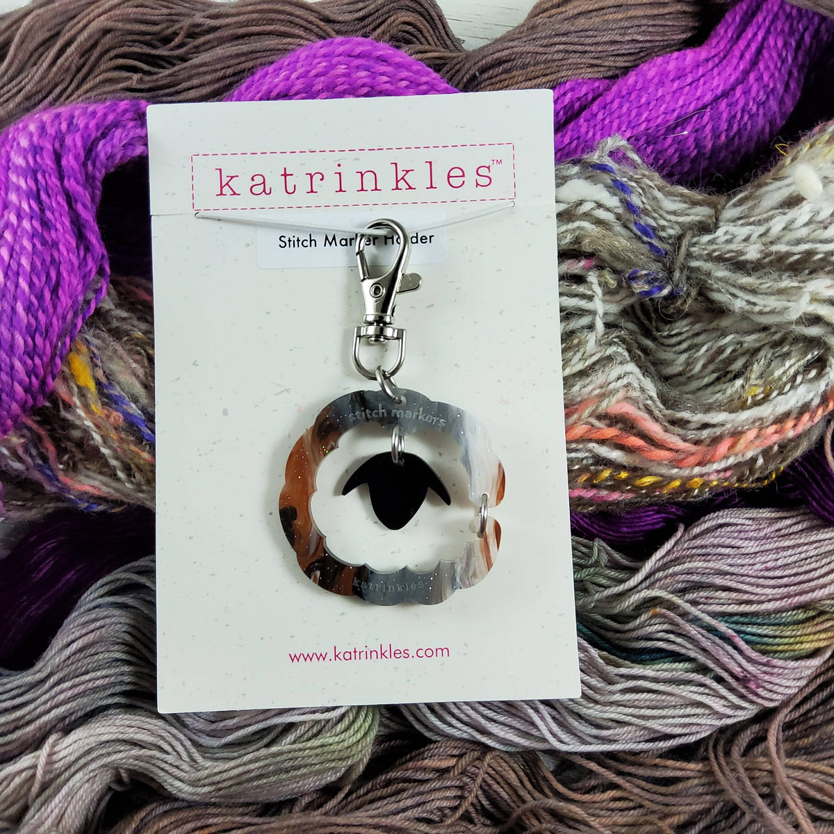 Katrinkles purse bag charm with stitch marker holder design on colorful yarn background