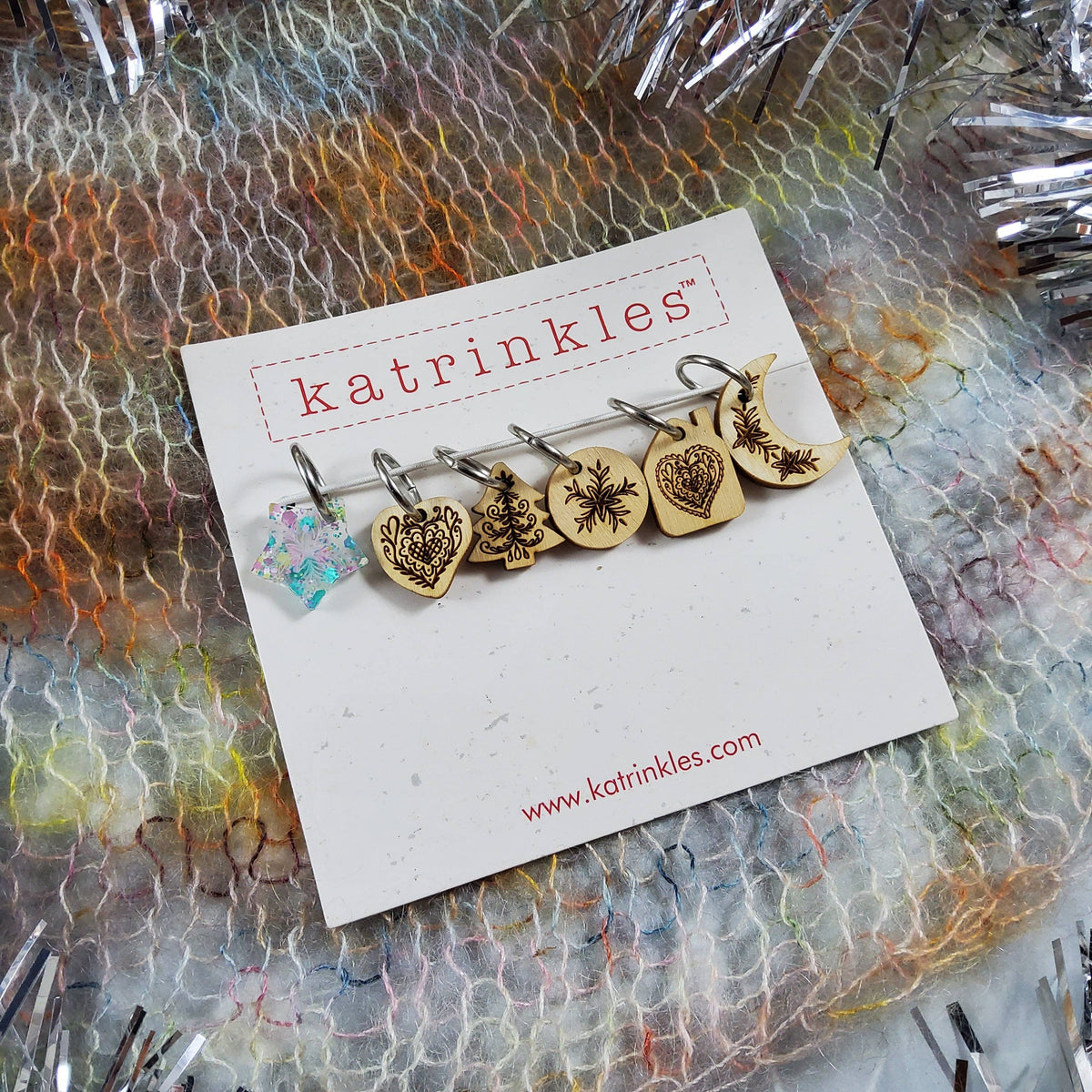 Set of Katrinkles wooden stitch markers for crocheting with decorative designs on each marker