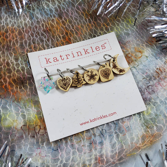 Set of Katrinkles wooden stitch markers for crocheting with decorative designs on each marker