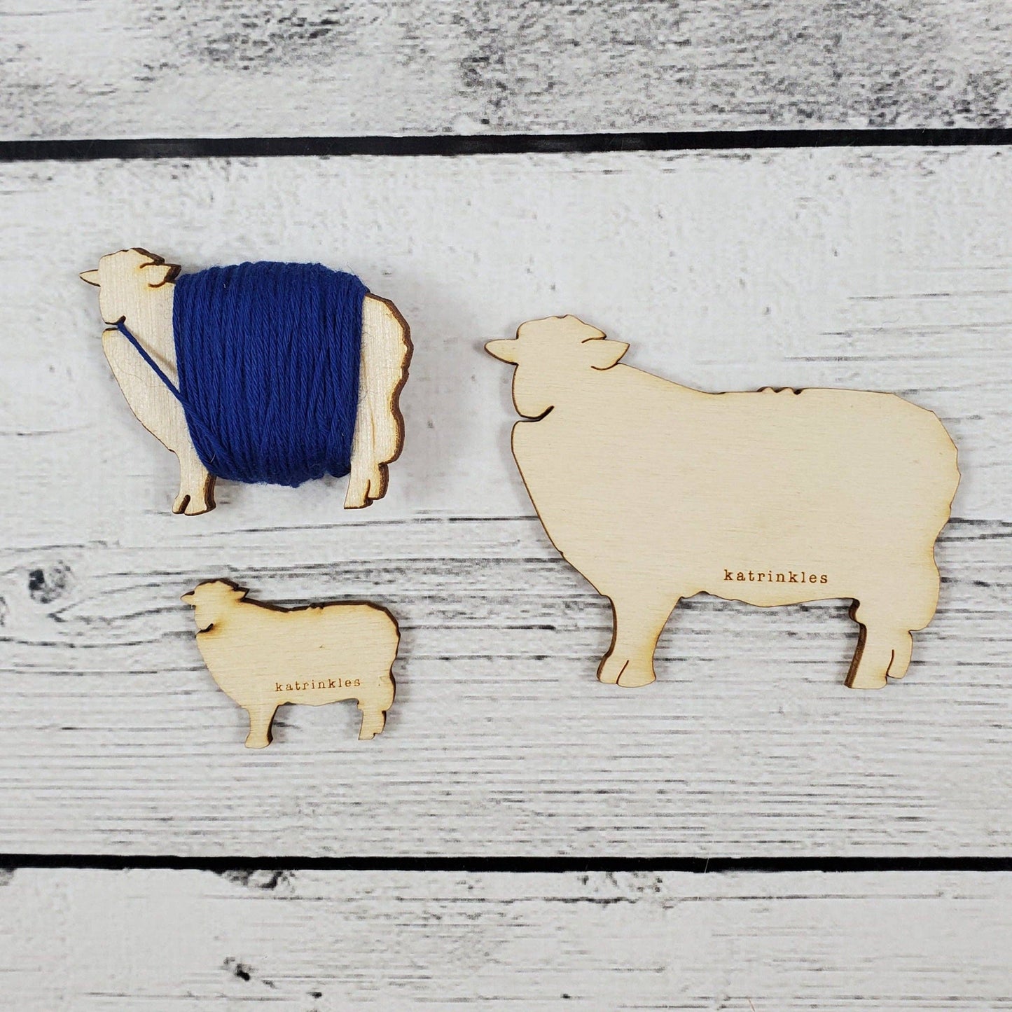 Set of Katrinkles vintage wooden bobbins shaped like sheep for holding yarn
