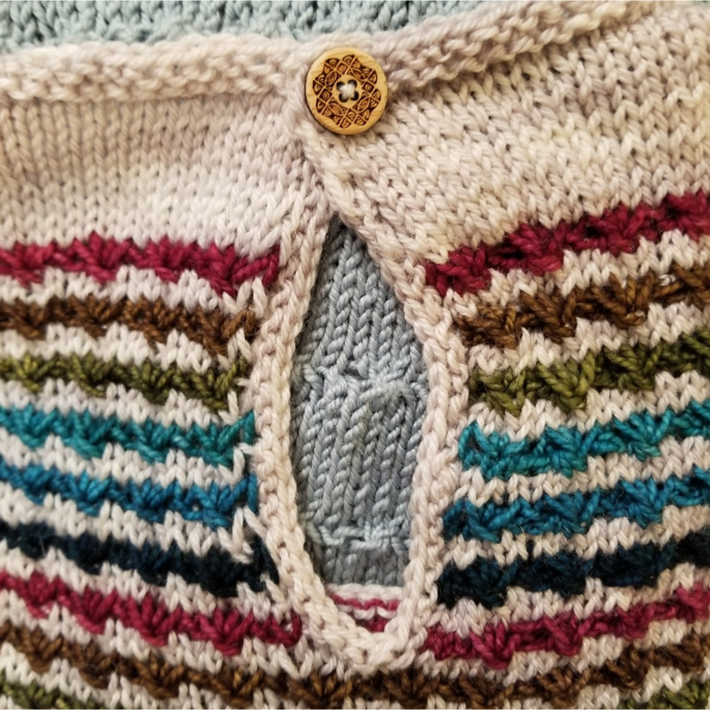 Katrinkles hand-knitted striped sweater with a unique button closure design