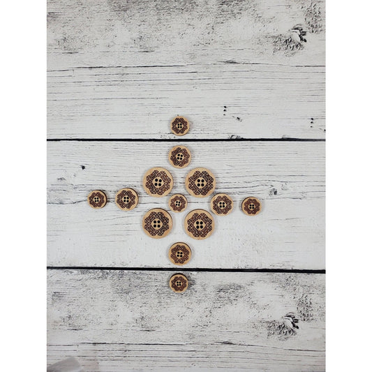 Katrinkles laser-cut wooden stitch markers in various sizes arranged on a white wooden background