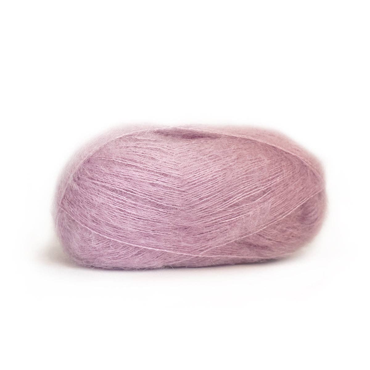 Soft lavender Kelbourne Woolens Harmony yarn in a light, fluffy ball for knitting and crochet projects