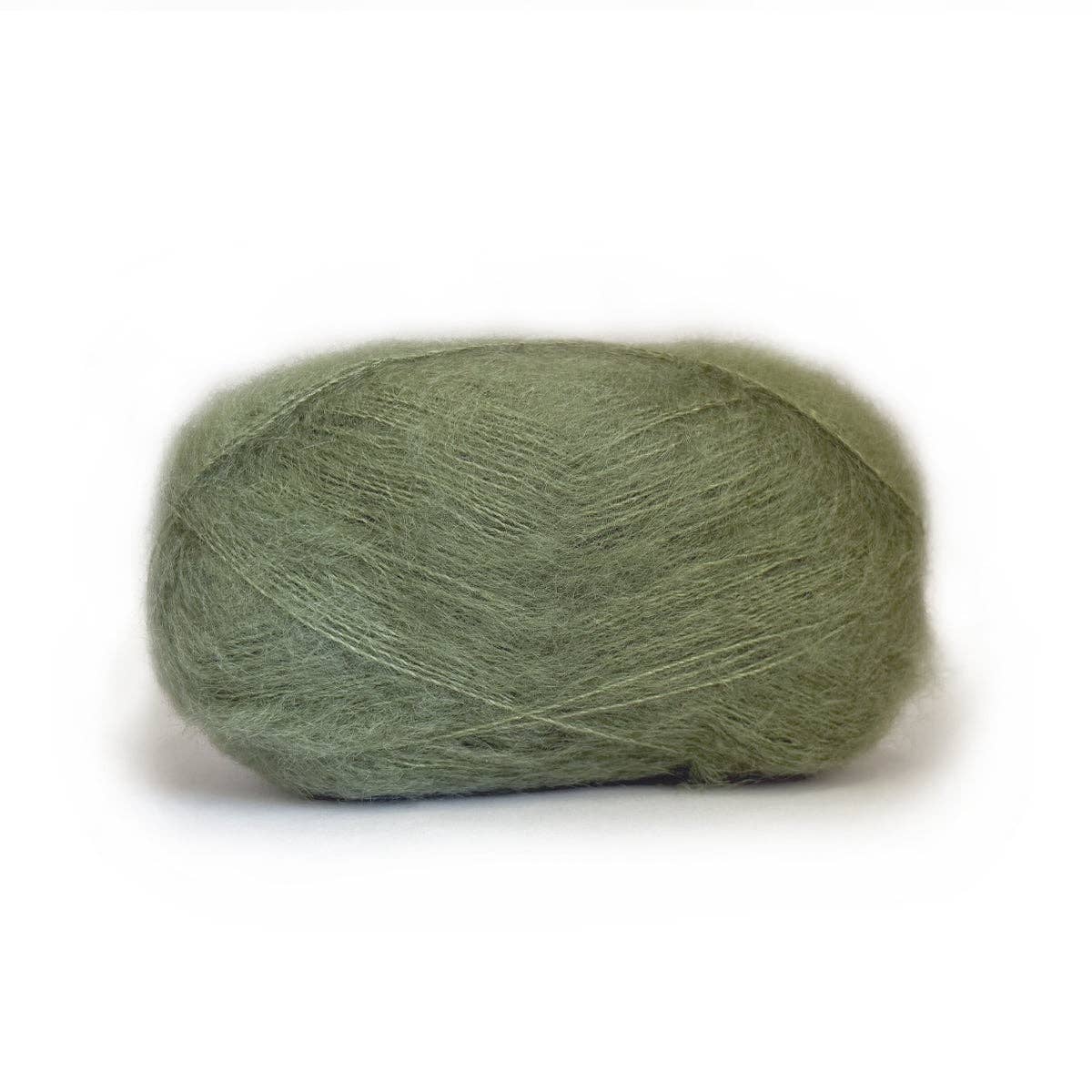 Kelbourne Woolens Harmony yarn in soft green, ideal for various knitting and crochet projects