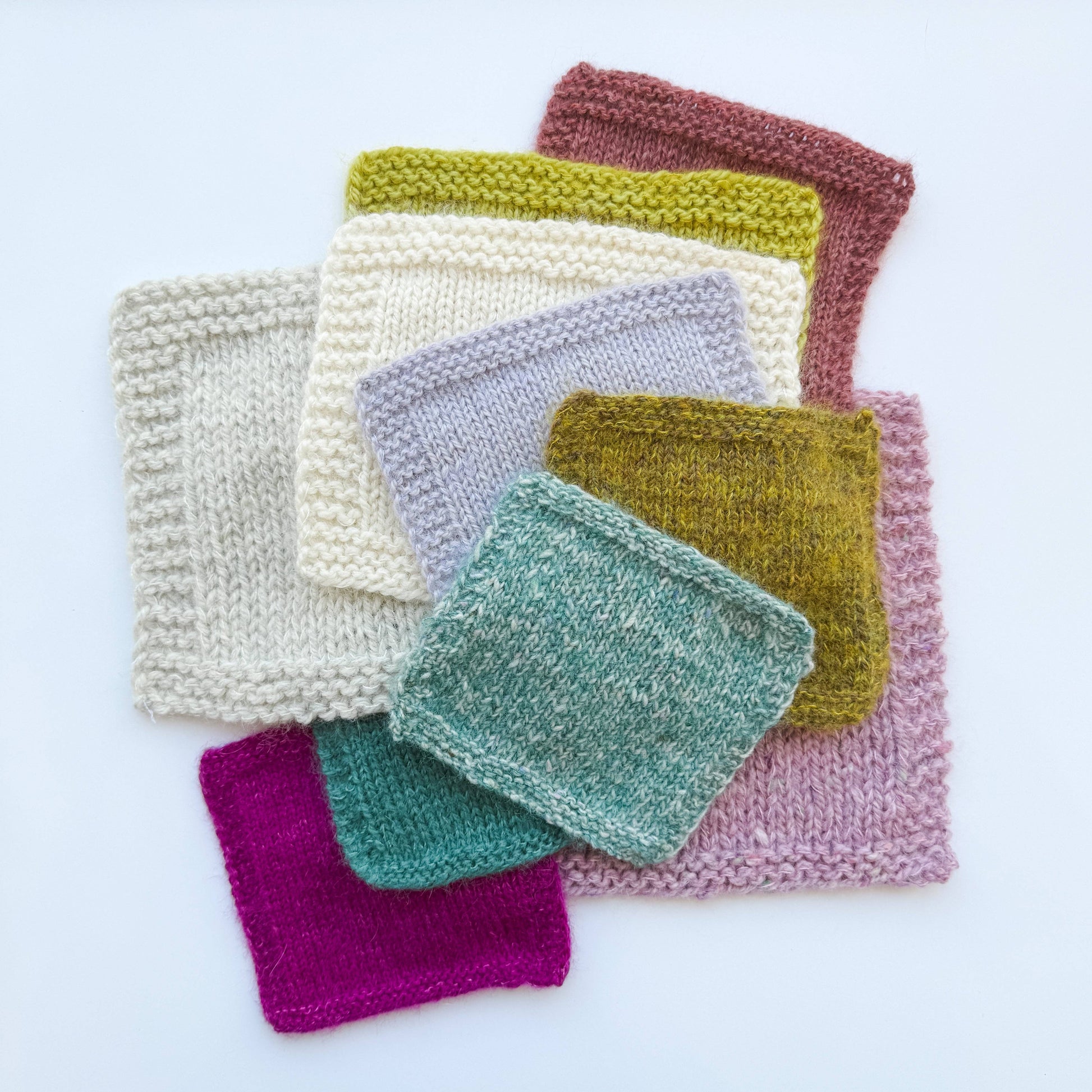Colorful knitted swatches made with Kelbourne Woolens Harmony yarn showcasing various textures