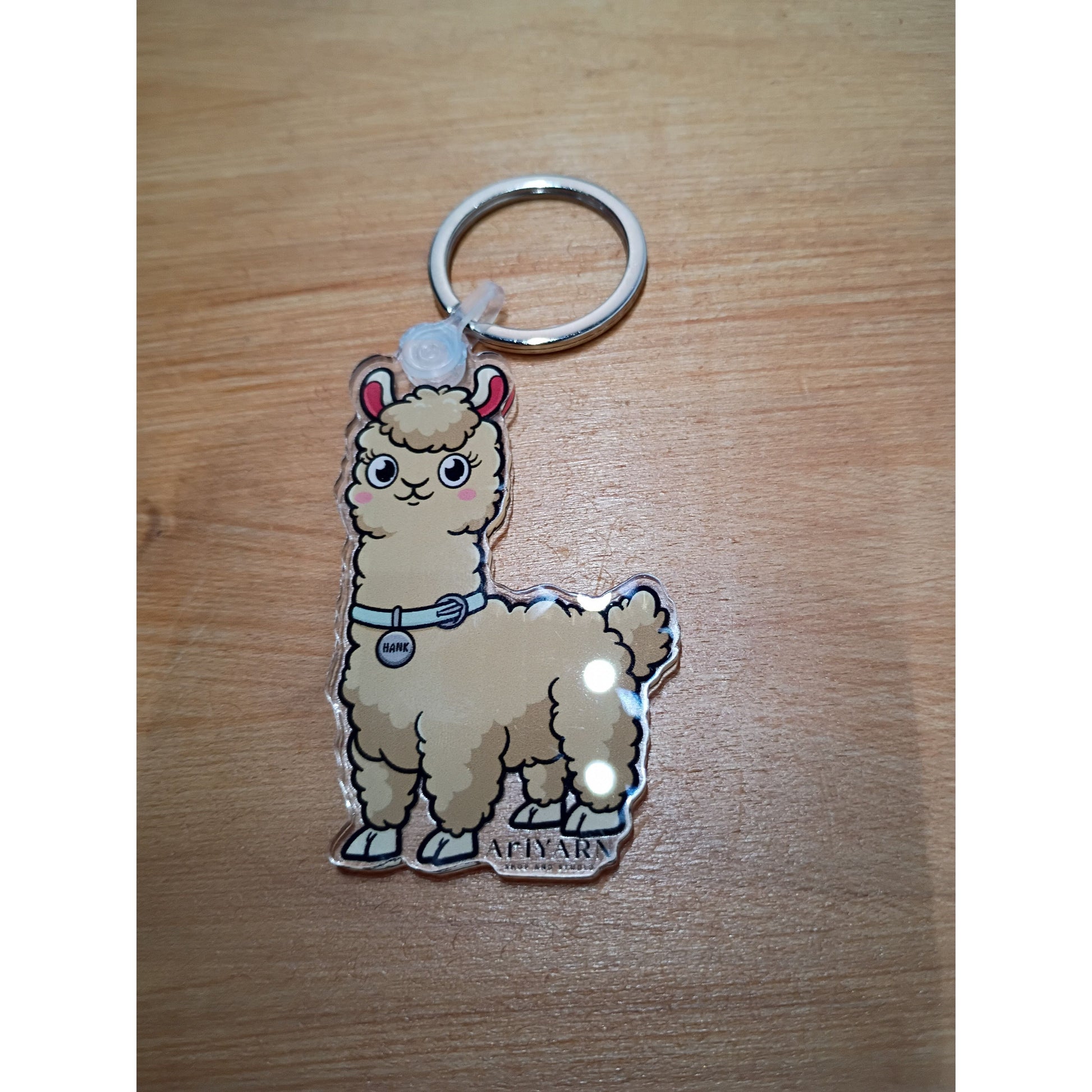 Cute llama acrylic keychain accessory with vibrant colors and cheerful design from AriYARN Shop and Studio