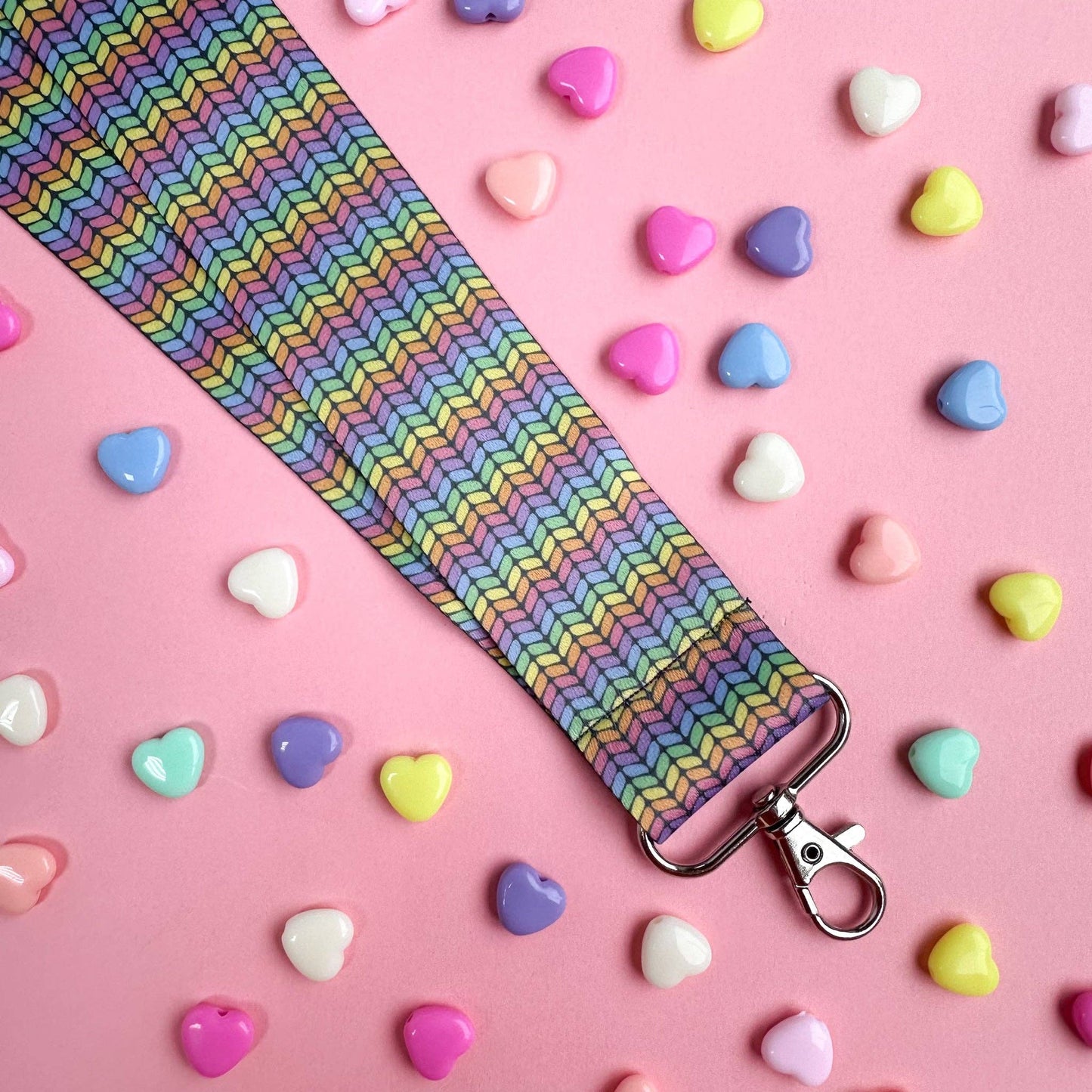 Colorful hello kitty lanyard with a rainbow pattern and a silver clip for keys or ID badges