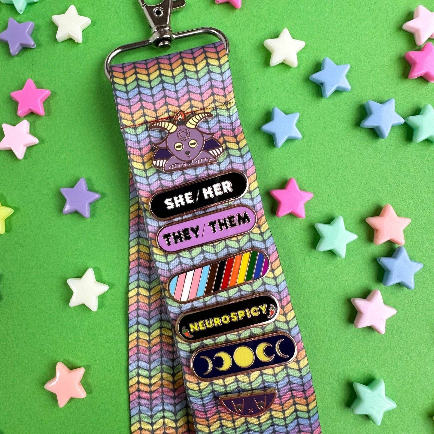 Colorful hello kitty lanyard with various badge designs showcasing pride and creativity
