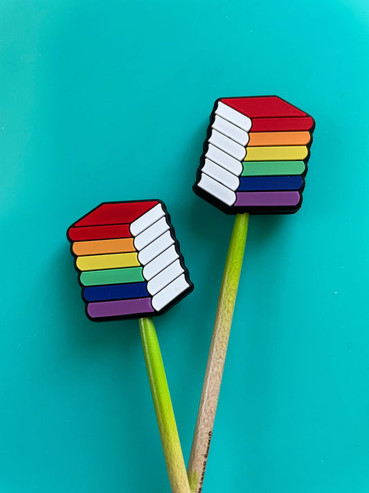 Comma Craft Co rainbow knitting needle point protectors set of two colorful stacked book shaped toppers on green needles