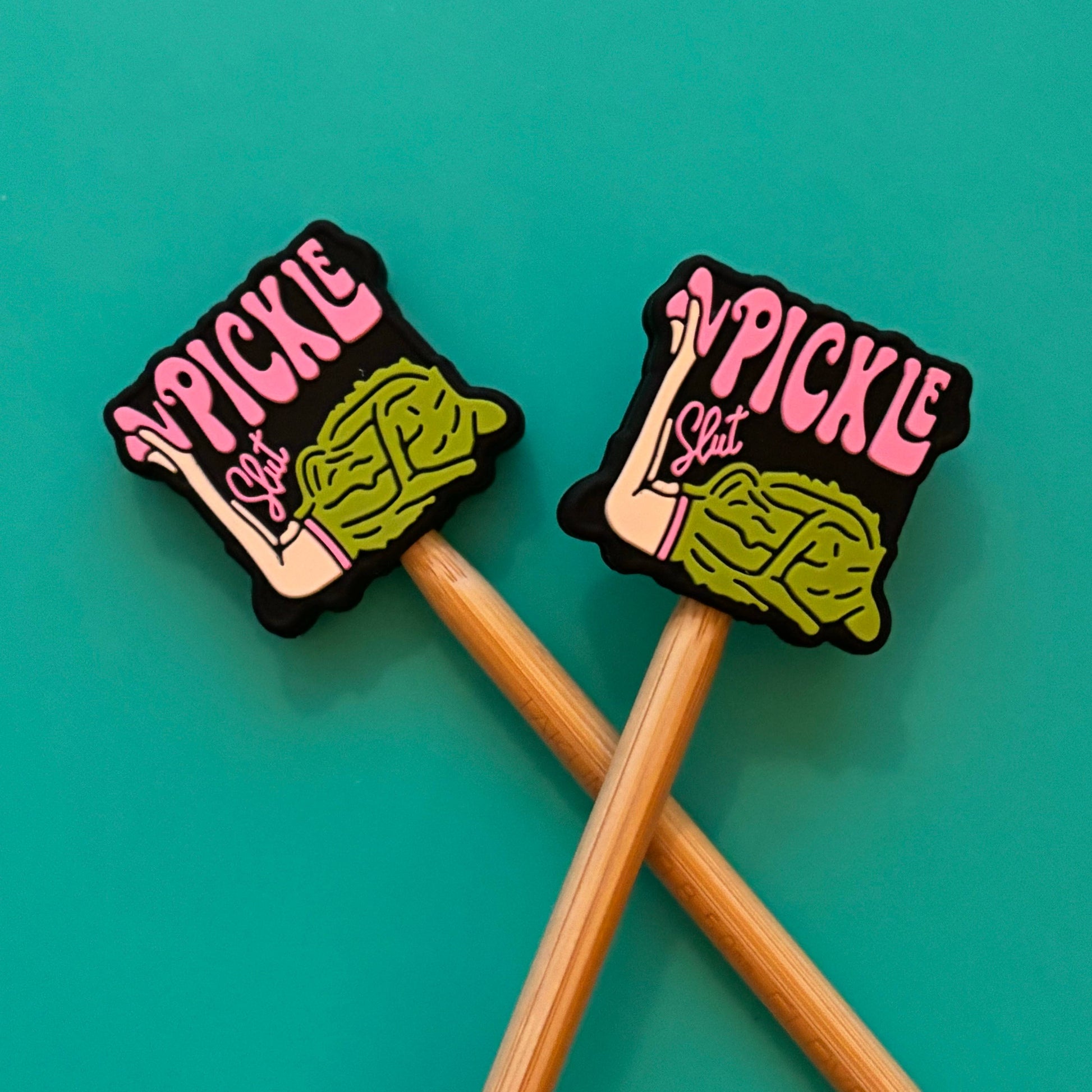 Two pickle themed point protectors for knitters on bamboo needles green pickle design on teal background
