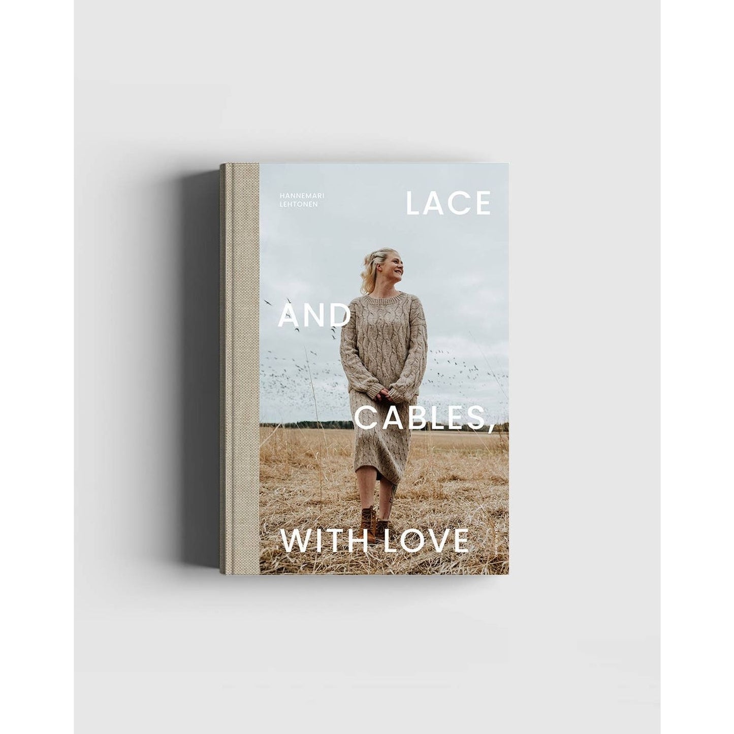 Lace and Cables, With Love knitting book featuring a model wearing a cozy knitting cable sweater