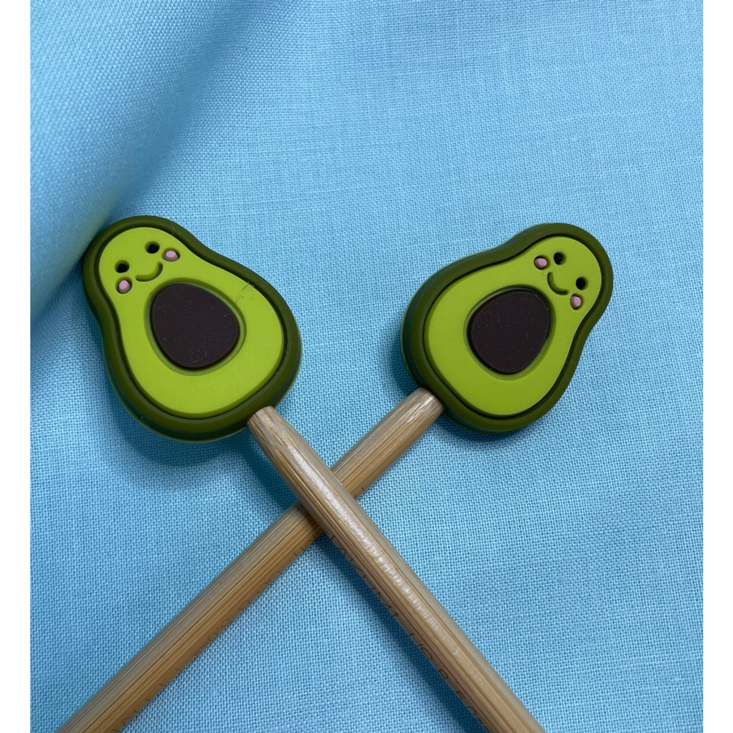 Cute avocado knitting needle set by Comma Craft Co with smiling designs and wooden shafts