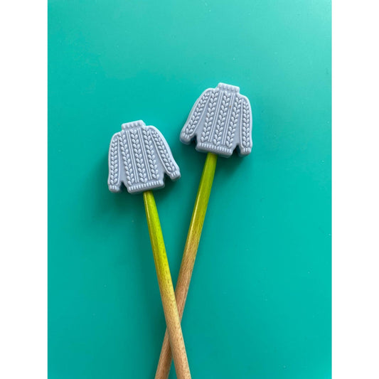 Knitting needle point protectors shaped like gray sweaters for safeguarding projects