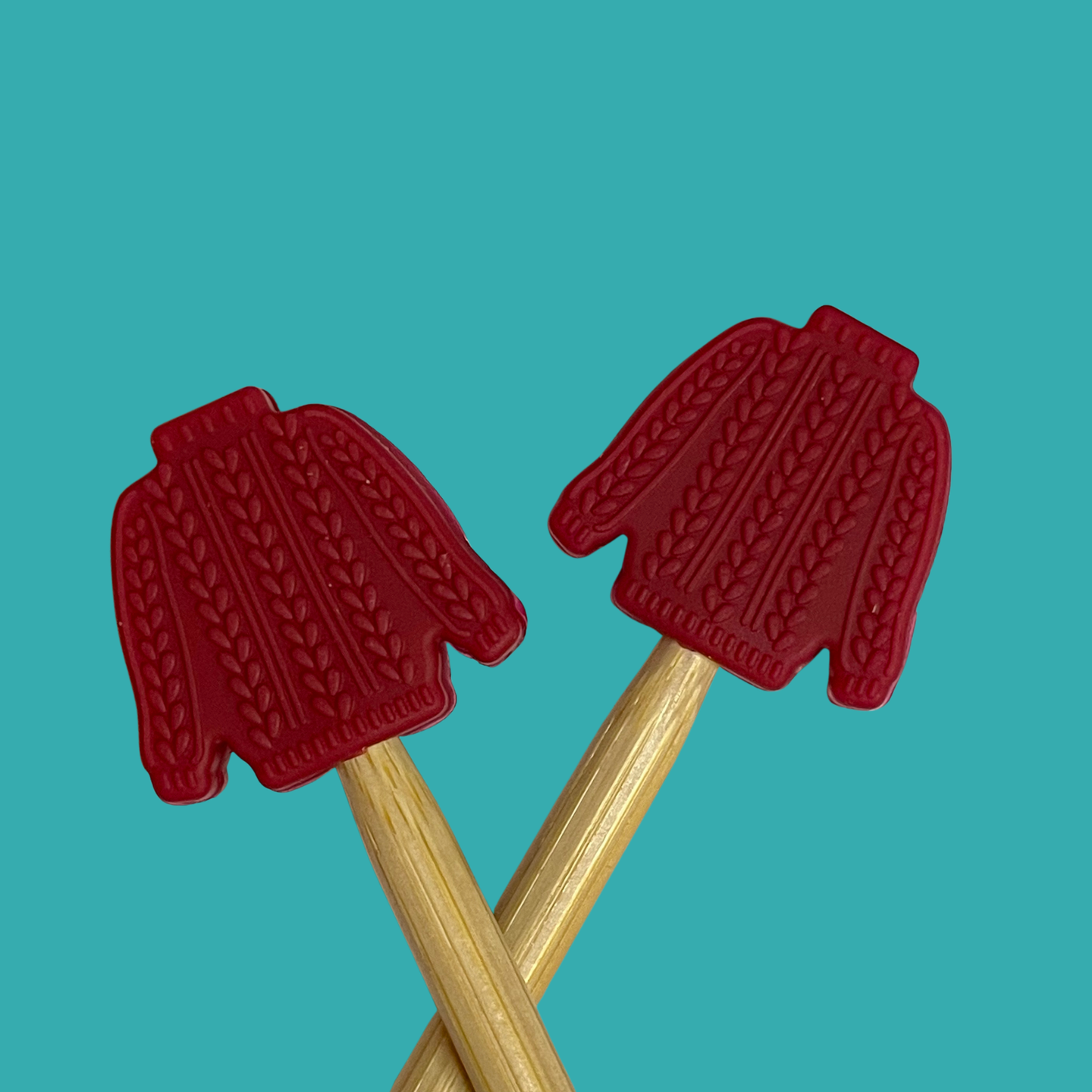 Red sweater-shaped knitting needle point protectors from Comma Craft Co for knitting projects