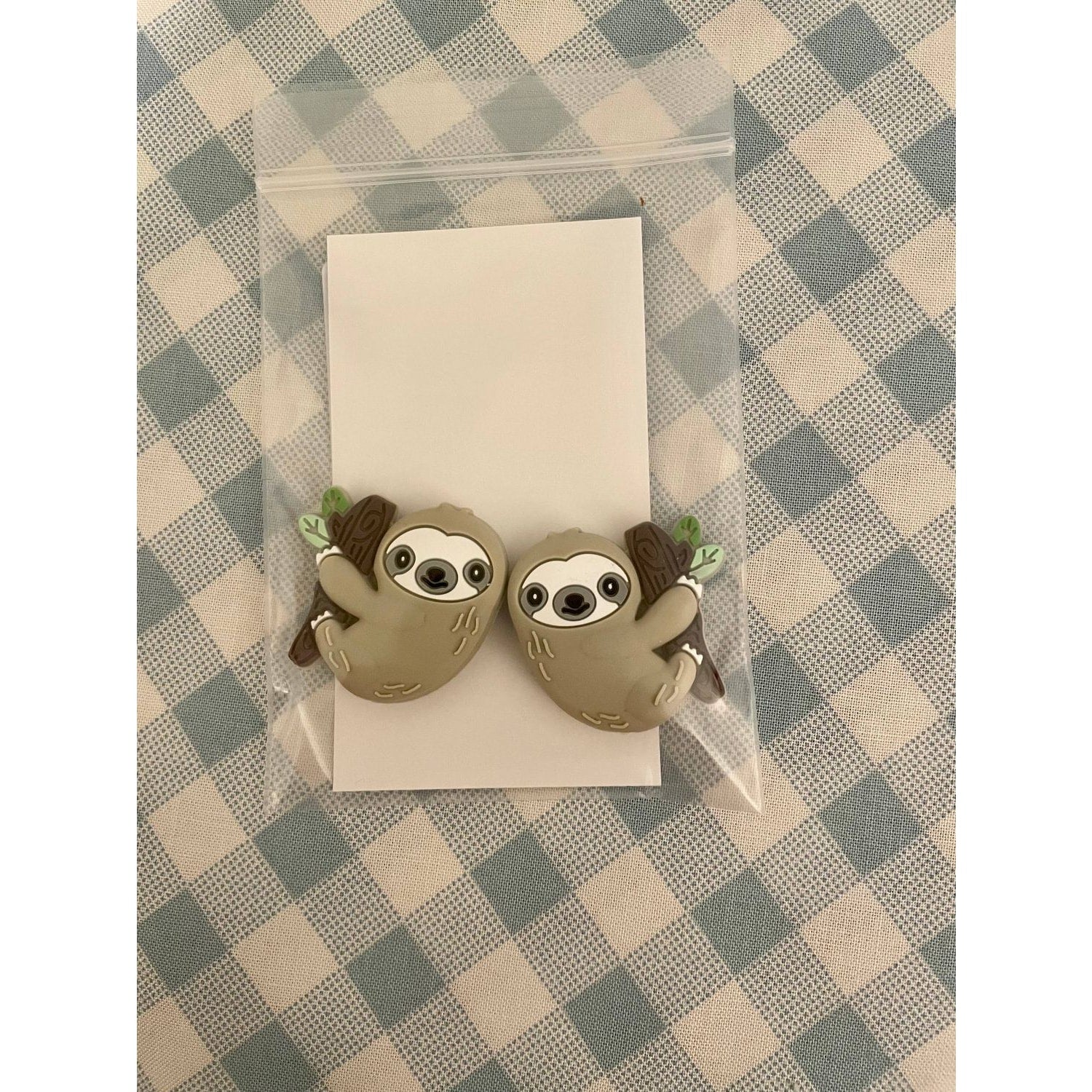 Cute sloth-themed knitting needle protectors by Comma Craft Co for knitting enthusiasts